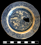 Refined white earthenware cup plate printed underglaze in Blue Willow pattern. Rim diameter: 4.50”. Lot: 5, Provenience:1G.396.1, Privy Stratum 2. 18BC38